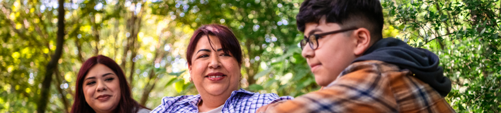 Maricela is with children and smiling.